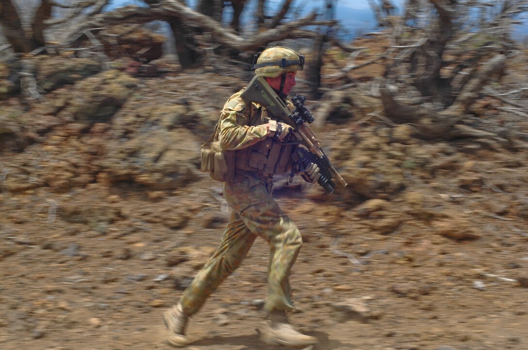 An Australian Soldier sprints to his next position during a platoon-size movement range as part of Rim of the Pacific, 2012, July 19. Approximately 2,200 personnel from 9 nations comprise SPMAGTF-3, Combined Force Land Component Command. The CFLCC is conducting amphibious and land-based operations in order to enhance multinational and joint interoperability.