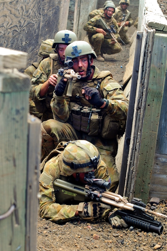 Australian Army Pvt. Aaron "Willy" Williams searches for targets after his squad cleared a trench line position during a platoon-size movement range as part of Rim of the Pacific, 2012, July 19. Approximately 2,200 personnel from 9 nations comprise SPMAGTF-3, Combined Force Land Component Command. The CFLCC is conducting amphibious and land-based operations in order to enhance multinational and joint interoperability.