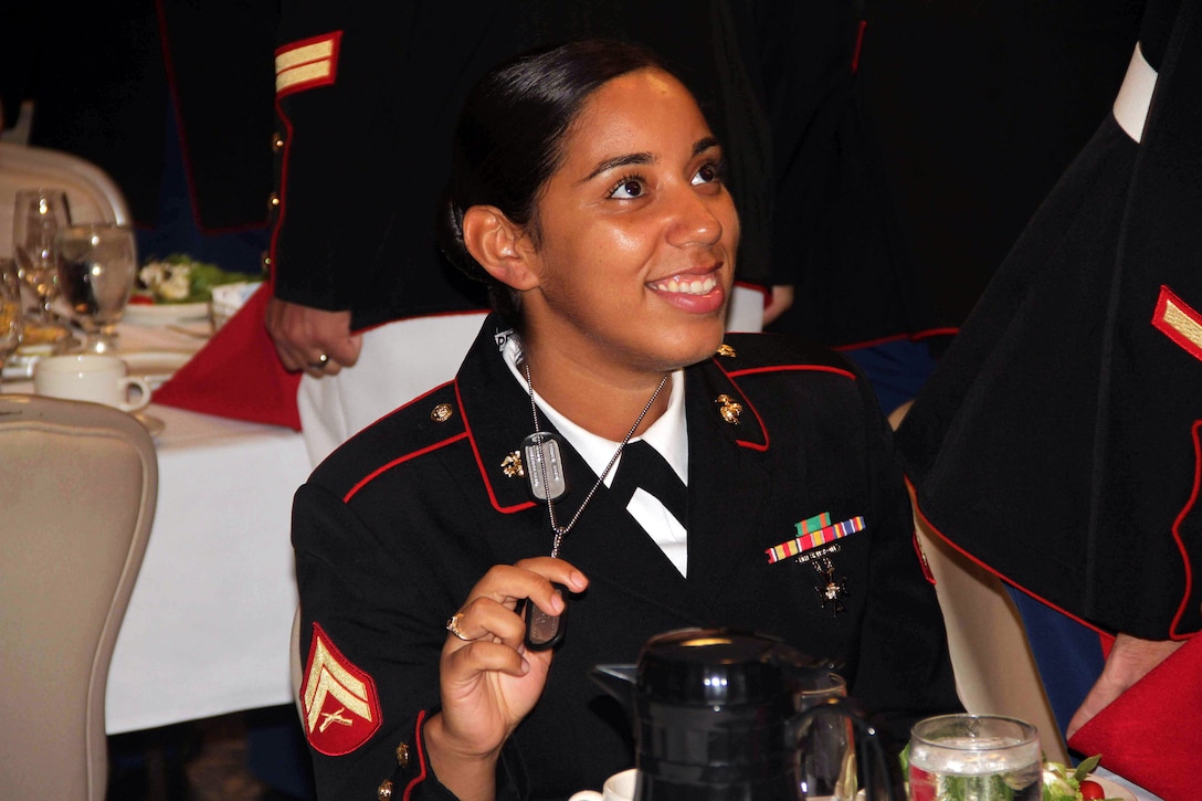 Cpl. Zugelly Perezsoto, 23, from Bronx, N.Y., proudly displays her dog tags to avoid a fine at the Marine Wing Support Squadron 471 I&I staff mess night on July 20. Anyone who couldn't produce their dog tags had to pay a $2 fine, inlcuding the guest of honor Ret. Maj. Gen. Gordon C. Nash. For additional imagery from the event, visit www.facebook.com/rstwincities.