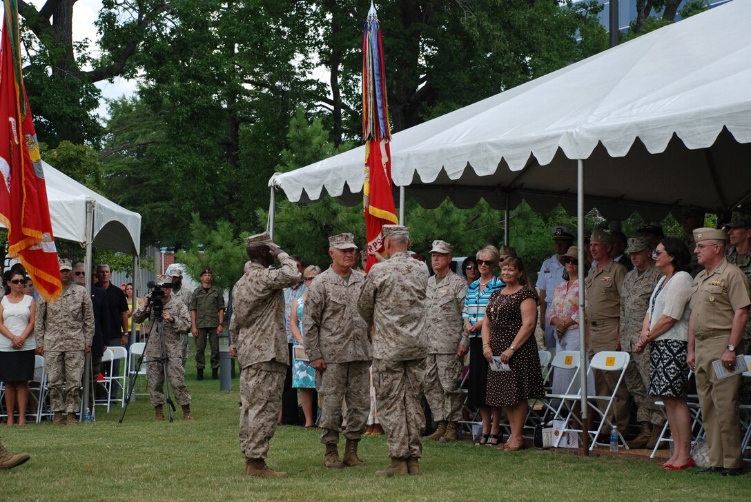 Lt. Gen. Dennis J. Hejlik (center) passes the colors of U.S. Marine Forces Command (MARFORCOM) to Lt. Gen. John M. Paxton, Jr. (right) during a change of command ceremony onboard Naval Support Activity Hampton Roads in Norfolk, July 20.