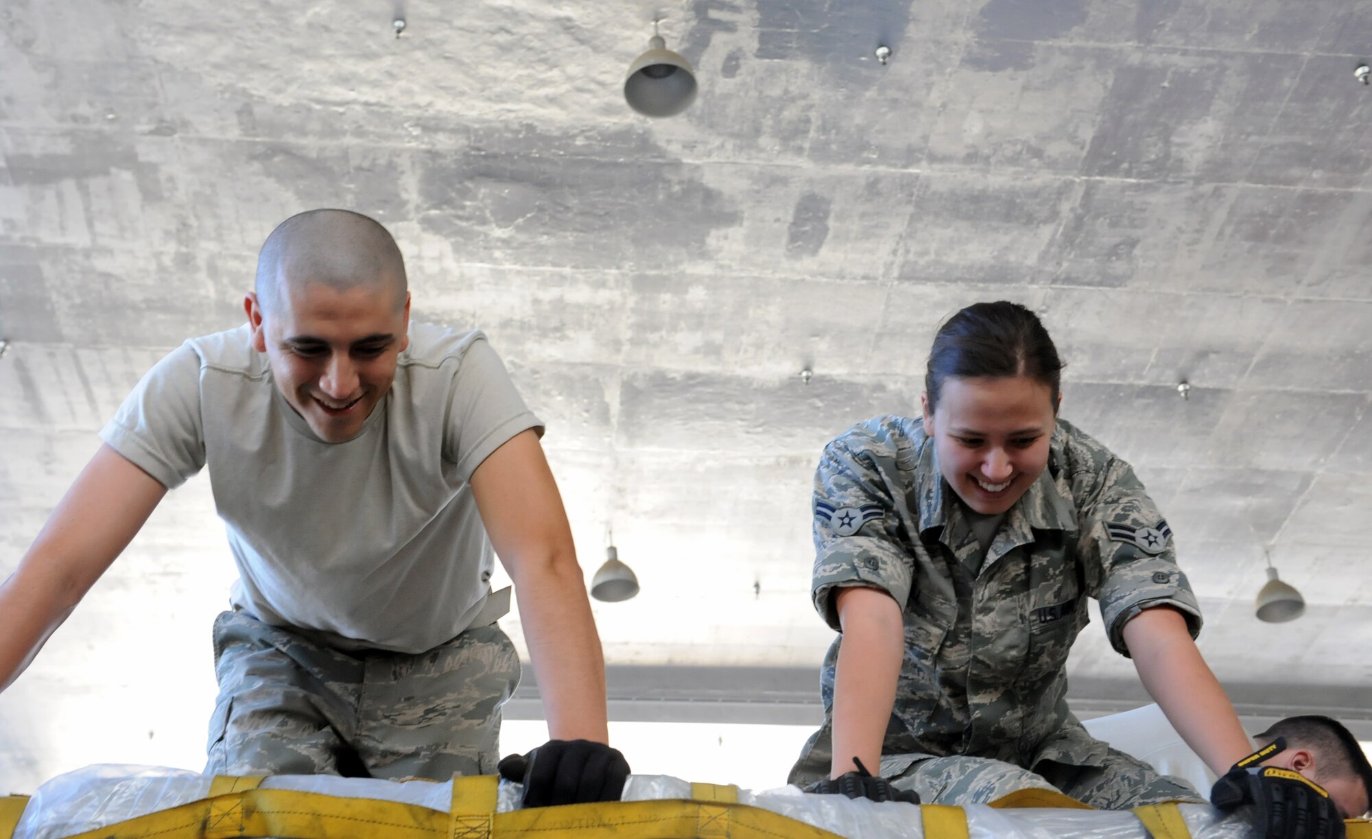 Staff. Sgt. Freddy Arriaga, non-commissioned officer-in-charge of storage and distribution, and Airman 1st Class Margaret Noll, 15th Medical Support Squadron Medical Materiel Journeyman, assemble a pallet in Hangar 4 during a 15th Medical Group training day session July 19 at Joint Base Pearl Harbor-Hickam, Hawaii. The Medical Logistics flight is responsible for ordering, storing and distributing medical supplies to 15th Medical Group clinics as well as storing and preparing medical supplies for contingency and deployment operations. (U.S. Air Force photo by Staff Sgt. Nathan Allen)
