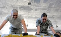 Staff. Sgt. Freddy Arriaga, non-commissioned officer-in-charge of storage and distribution, and Airman 1st Class Margaret Noll, 15th Medical Support Squadron Medical Materiel Journeyman, assemble a pallet in Hangar 4 during a 15th Medical Group training day session July 19 at Joint Base Pearl Harbor-Hickam, Hawaii. The Medical Logistics flight is responsible for ordering, storing and distributing medical supplies to 15th Medical Group clinics as well as storing and preparing medical supplies for contingency and deployment operations. (U.S. Air Force photo by Staff Sgt. Nathan Allen)
