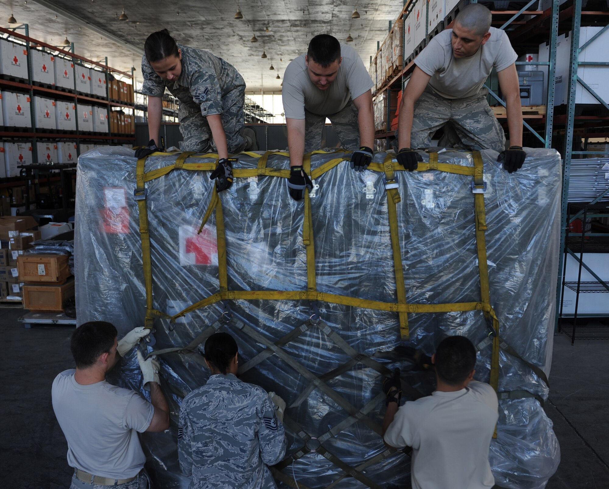 Members of the 15th Medical Logistics flight assemble a pallet in Hangar 4 during a 15th Medical Group training day session July 19 at Joint Base Pearl Harbor-Hickam, Hawaii. The flight is responsible for ordering, storing and distributing medical supplies to 15th Medical Group clinics as well as storing and preparing medical supplies for contingency and deployment operations. (U.S. Air Force photo by Staff Sgt. Nathan Allen)