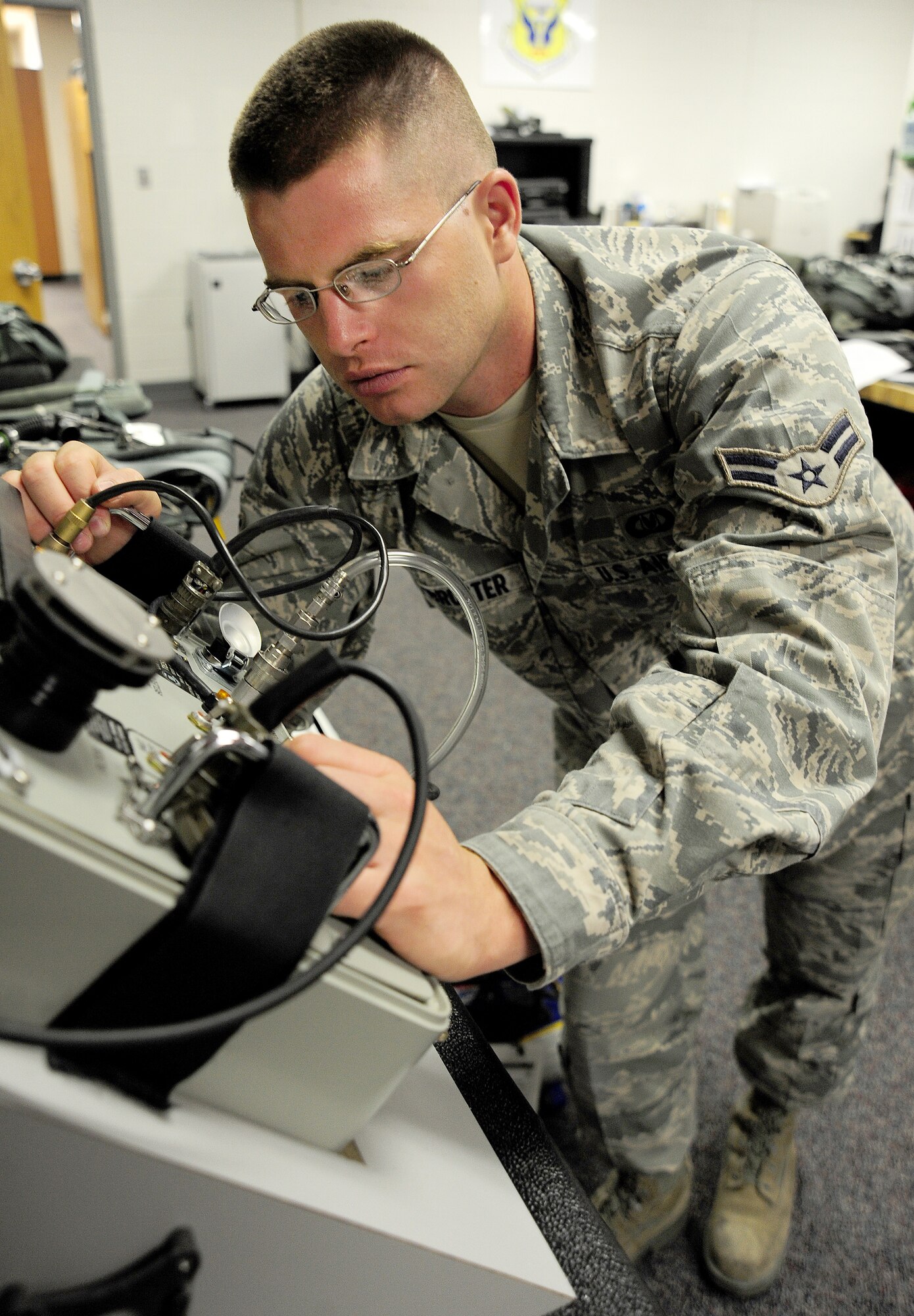 WHITEMAN AIR FORCE BASE, Mo. -- Airman 1st Class Nathaniel Armbruster, 509th Operations Support Squadron Aircrew Flight Equipment technician, tests the operational capabilities of an oxygen mask July 3. Technicians perform pre-flight, post-flight and 30-day safety checks of the helmets to ensure they can be used at a moment’s notice. (U.S. Air Force photo/Senior Airman Nick Wilson) (Released)
