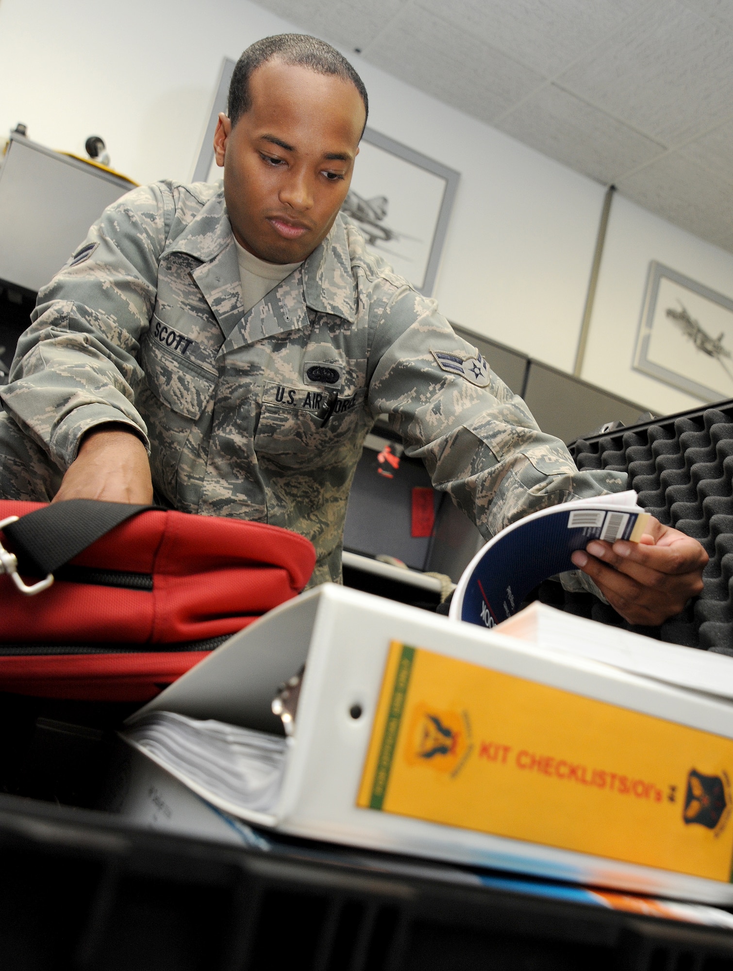 WHITEMAN AIR FORCE BASE, Mo. -- Airman 1st Class Kenneth Scott, 509th Operations Support Squadron Combat Crew Communications technician, prepares a deployment kit with all the necessary equipment he needs for his job, July 3. As a Combat Crew Communications Airman, some of Scott’s duties include managing and safeguarding communications security materials used by B-2 Spirit aircrews. (U.S. Air Force photo/Senior Airman Nick Wilson) (Released)