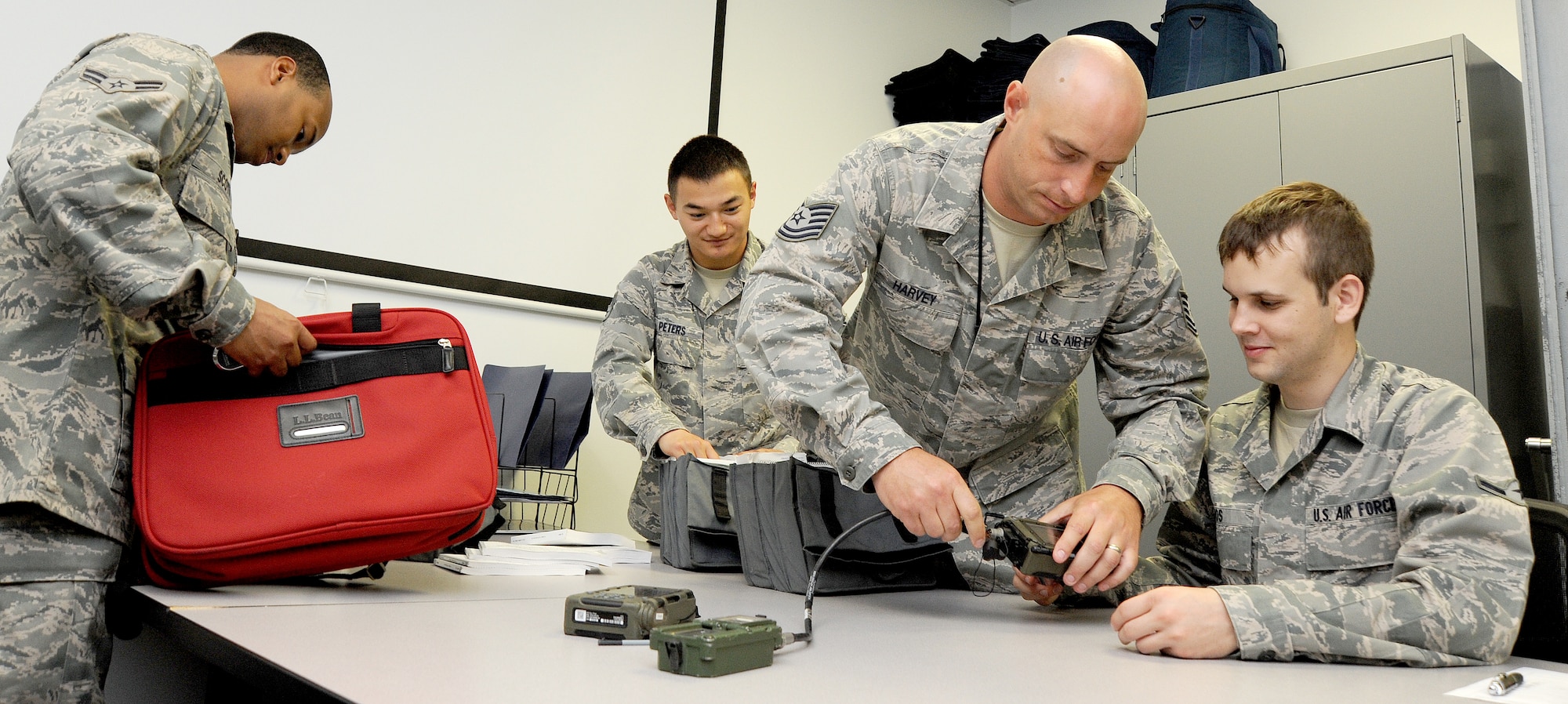WHITEMAN AIR FORCE BASE, Mo. -- Airmen from the 509th Operations Support Squadron Combat Crew Communications flight, inspect a daily communications kit, July 3. The inspection ensures all communications information has been verified and ready for future missions. (U.S. Air Force photo/Senior Airman Nick Wilson) (Released)