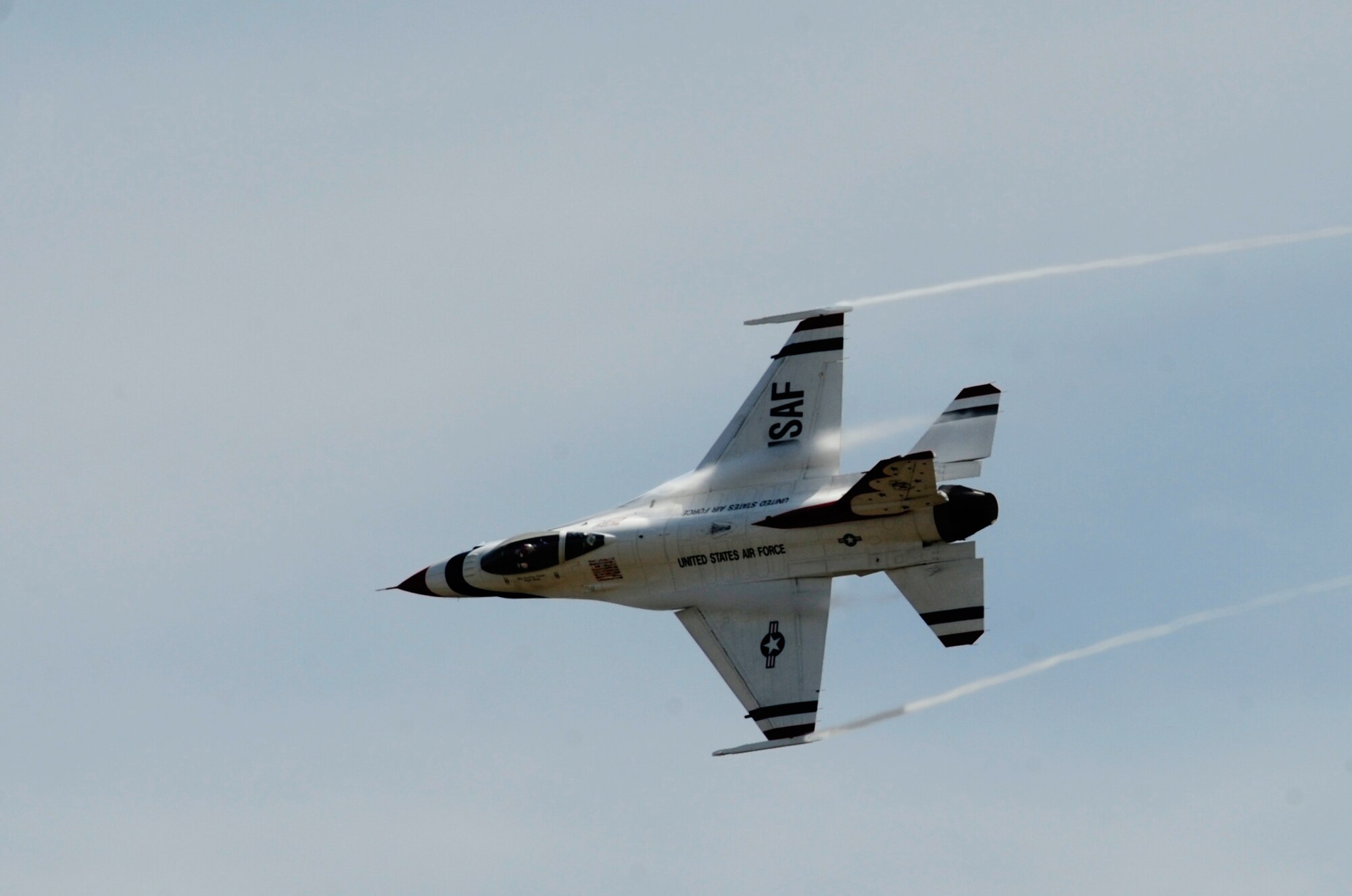 An F-16 Fighting Falcon with the U.S. Air Force Thunderbirds conducts a site survey of McChord Field prior to landing July 19, 2012, at Joint Base Lewis-McChord, Wash. Officially known as the U.S. Air Force Air Demonstration Squadron, the Thunderbirds team is an Air Combat Command unit composed of eight pilots (including six demonstration pilots), four support officers, four civilians and more than 100 enlisted people serving in about 30 Air Force job specialties. (U.S. Air Force photo/Adamarie Lewis-Page) 