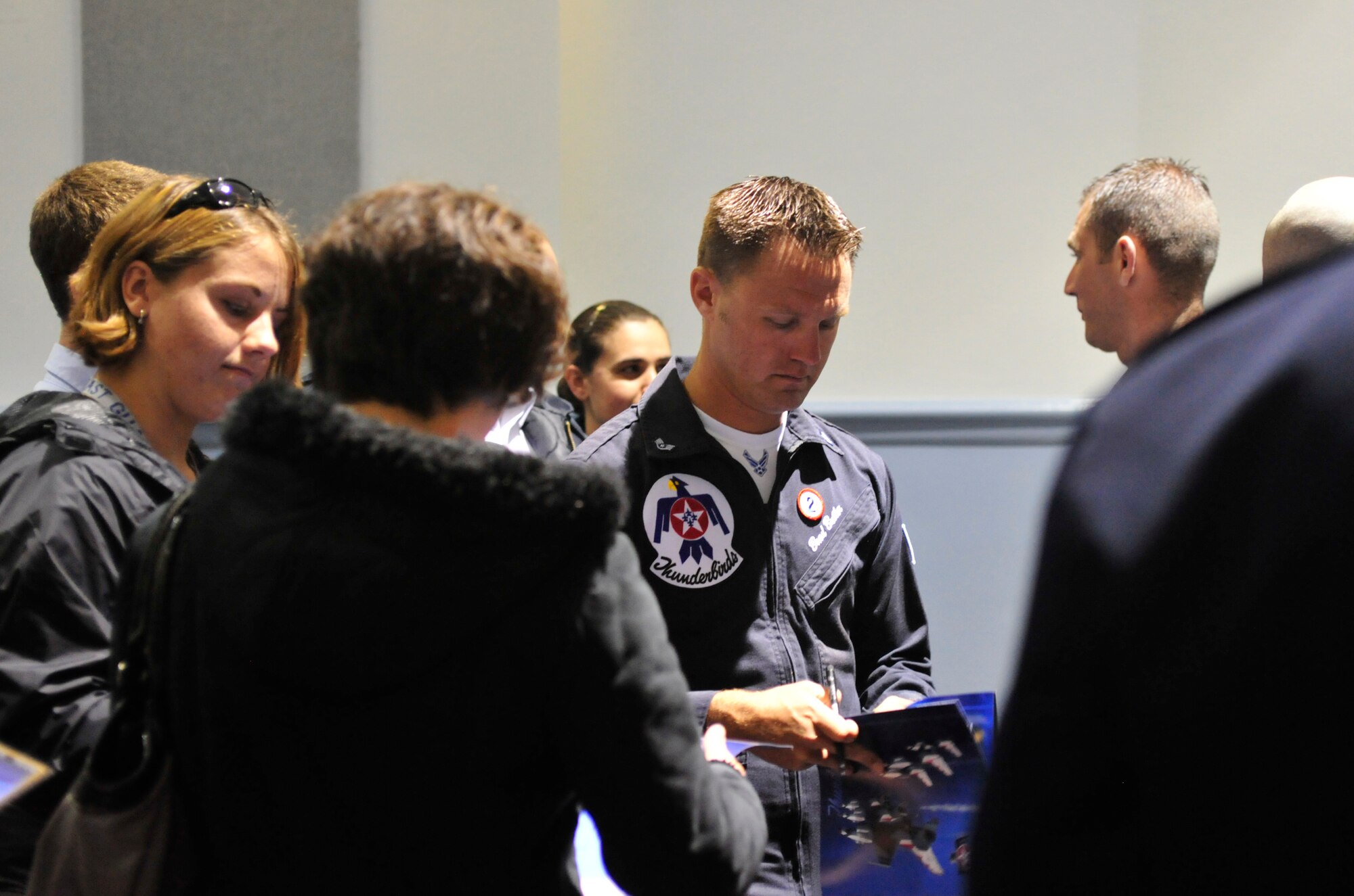 Capt. Ryan Riley, U.S. Air Force Thunderbird pilot, signs autographs for a group of junior ROTC and Civil Air Patrol cadets July 20, 2012, at Joint Base Lewis-McChord, Wash. The cadets had an opportunity to meet with the teams who will be performing in the 2012 Joint Base Lewis-McChord Air Expo to include the Thunderbirds, U.S. Army Golden Knights and Air Combat Command Viper West Demonstration Team. (U.S. Air Force photo/Staff Sgt. Frances Kriss)
