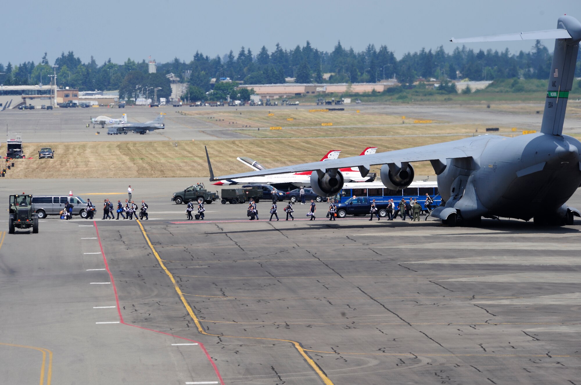 The U.S. Air Force Thunderbirds team arrive July 19, 2012, at Joint Base Lewis-McChord, Wash. Officially known as the U.S. Air Force Air Demonstration Squadron, the Thunderbirds team is an Air Combat Command unit composed of eight pilots (including six demonstration pilots), four support officers, four civilians and more than 100 enlisted people serving in about 30 Air Force job specialties. (U.S. Air Force photo/Adamarie Lewis-Page)