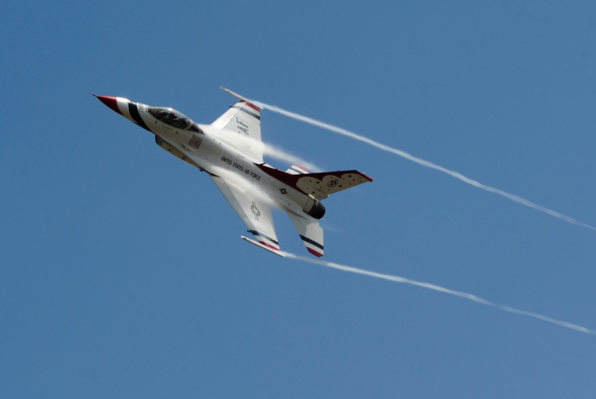 An F-16 Fighting Falcon with the U.S. Air Force Thunderbirds conducts a site survey of McChord Field prior to landing July 19, 2012, at Joint Base Lewis-McChord, Wash. The demonstration team will be one of the headliners for the 2012 Joint Base Lewis-McChord Air Expo. (U.S. Air Force photo/Adamarie Lewis-Page)
