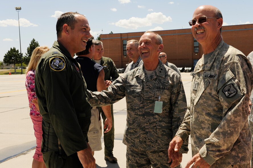 Col. William B. “Brad” Richy, left, prior commander of the 124th Fighter Wing, shakes hands with The Adjutant General Maj. Gen. Gary Sayler and Army Chief Warrant Officer 5 Bradley Brummett after he completes his Finis Flight at Gowen Field July 20. Col. Richy becomes the new director of Idaho Bureau of Homeland Security July 23.