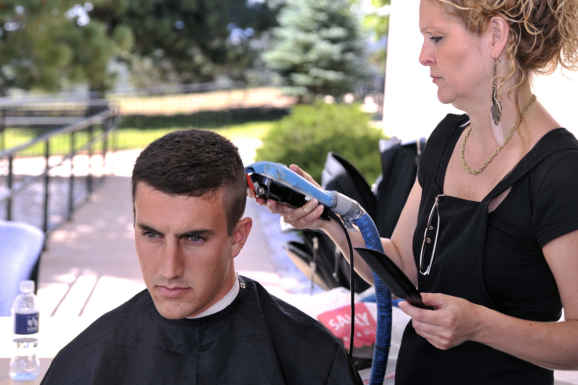 A fresh haircut is all part of a cadet candidate's introduction to cadet life during inprocessing at the Air Force Academy Preparatory School July 18. (U.S. Air Force Photo/Raymond McCoy)