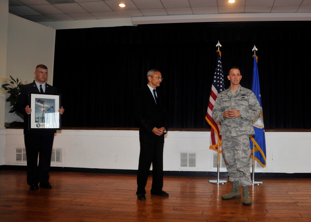 Col. Bill Knight, Joint Base Andrews/11th Wing commander, far right, presents John Podesta, former White House Chief of Staff to President Clinton and current Georgetown University Law Center visiting professor, with a  gift commemorating Podesta’s appearance at the July 20 Andrews Leadership Series. During his speech, Podesta urged all in attendance to value the perspectives and strong opinions of good leaders. (U.S. Air Force photo/Senior Airman Lindsey A. Porter)