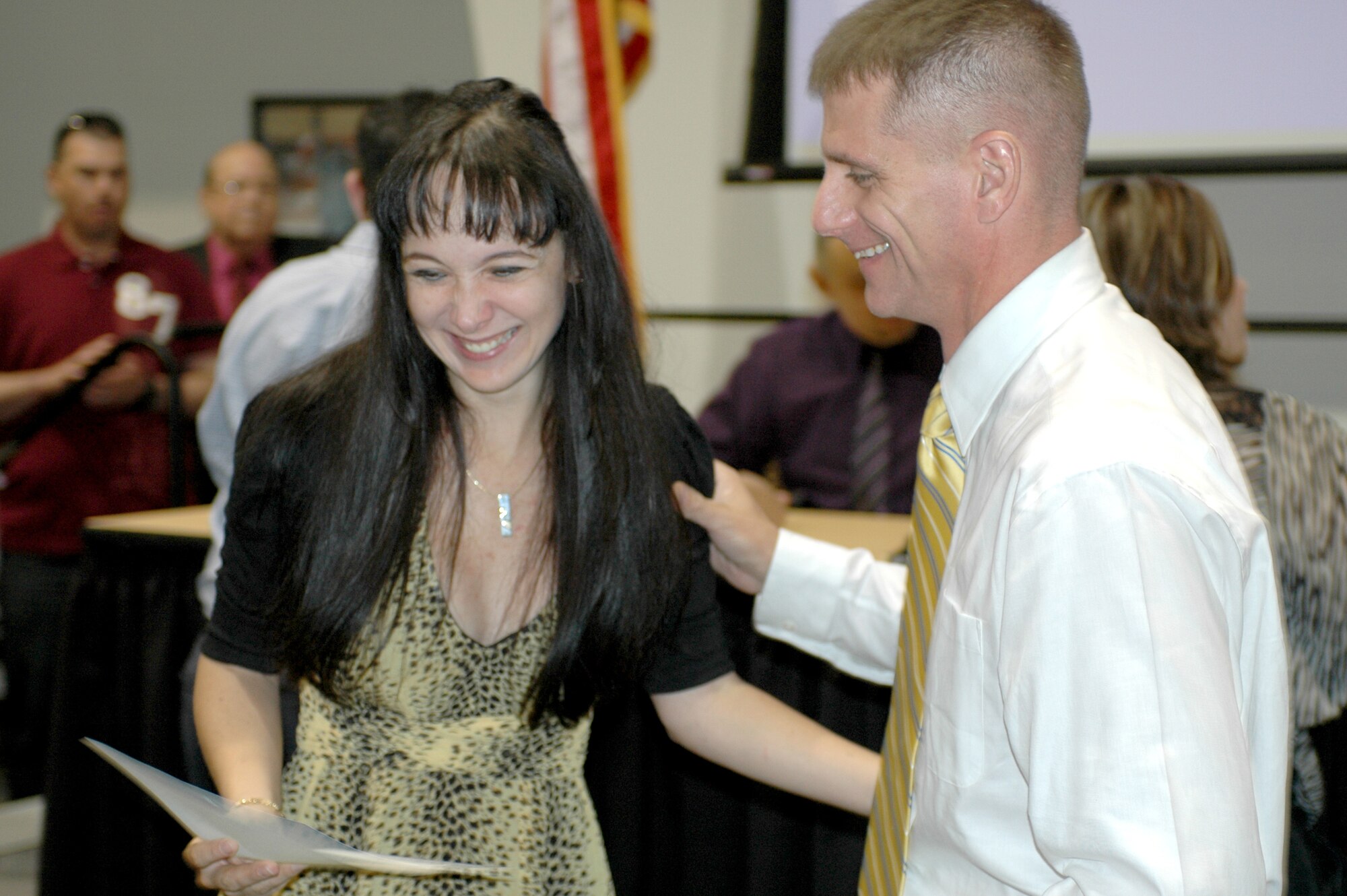 Vivian Gutierrez de Pineres shows her husband, Army Capt. Tim Cullers, her certificate of U.S. citizenship at a naturalization ceremony at the U.S. District Court in Tucson, Ariz., July 20. Gutierrez will serve her new country as a member of the Arizona Air National Guard. She reports to Air Force Basic Training July 24. (U.S. Air Force photo/Maj. Gabe Johnson)