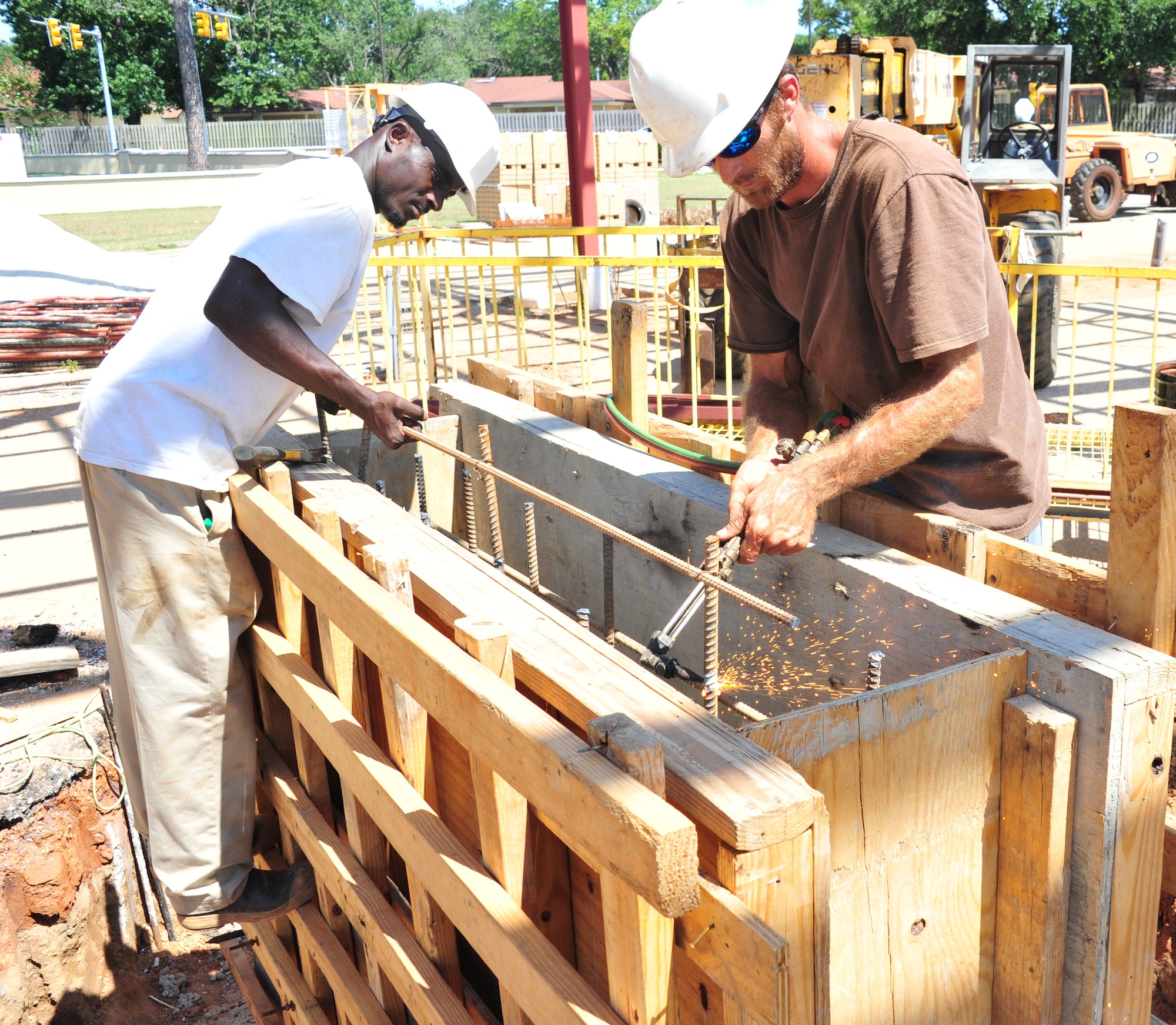 Contracted construction workers LeQuinton Orum and Keith Johnson begin assembly of a support beam for Gunter Annex’s new front gate Monday. The gate, located on Congressman W L Dickinson in Montgomery, Ala., is expected to be completed in November. The new gate will provide the 42nd Security Forces Squadron more protection from the elements and vehicle inspection capabilities. (U.S. Air Force photo by Senior Airman Christopher Stoltz)