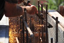 Contracted construction worker Keith Johnson begin assembly of a support beam for Gunter Annex’s new front gate Monday. The gate, located on Congressman W L Dickinson in Montgomery, Ala., is expected to be completed in November. The new gate will provide the 42nd Security Forces Squadron more protection from the elements and vehicle inspection capabilities. (U.S. Air Force photo by Senior Airman Christopher Stoltz)