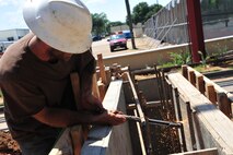 Contracted construction worker Keith Johnson begin assembly of a support beam for Gunter Annex’s new front gate Monday. The gate, located on Congressman W L Dickinson in Montgomery, Ala., is expected to be completed in November. The new gate will provide the 42nd Security Forces Squadron more protection from the elements and vehicle inspection capabilities. (U.S. Air Force photo by Senior Airman Christopher Stoltz)