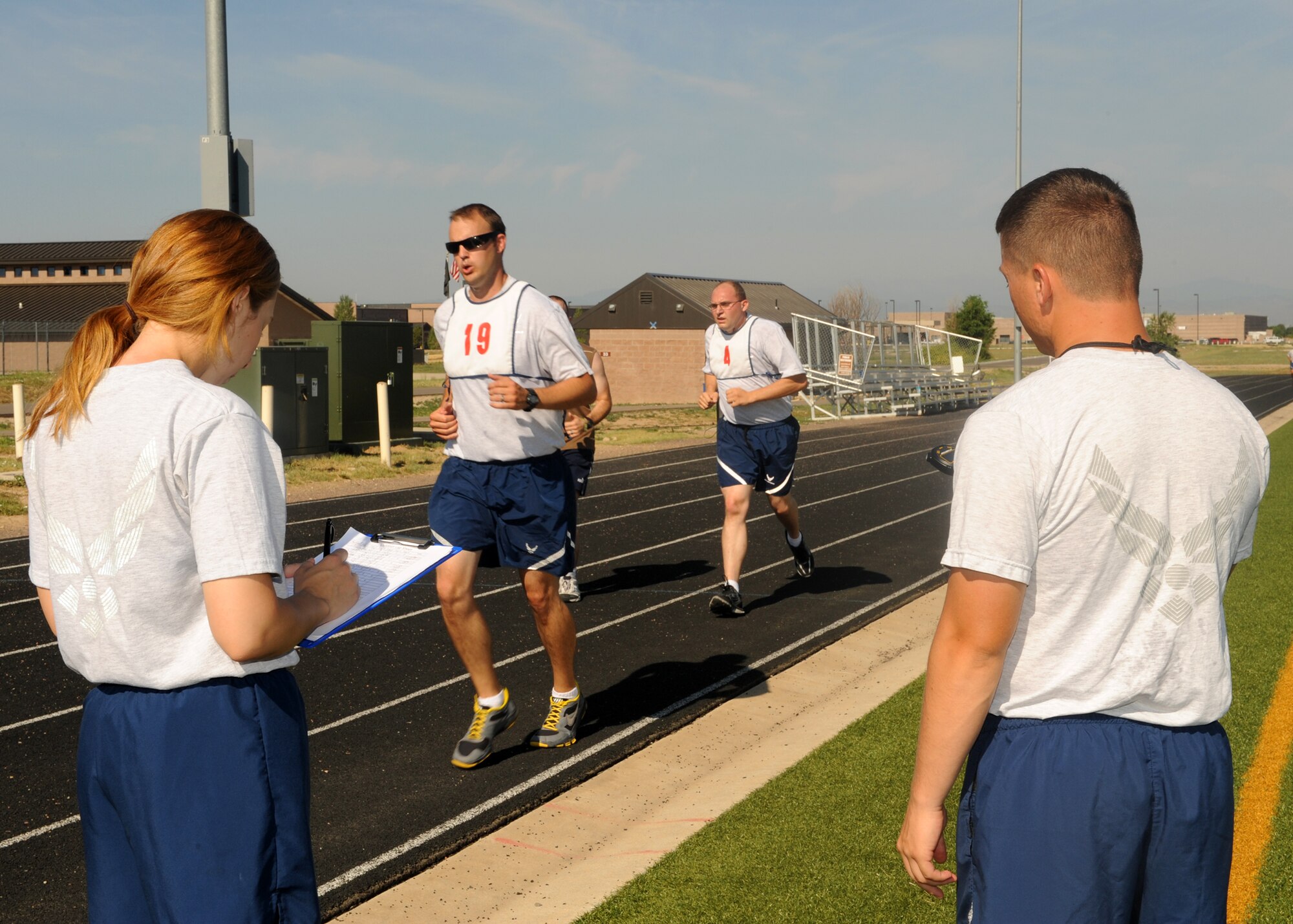 BUCKLEY AIR FORCE BASE, Colo. --Members of Team Buckley run the mile and a half portion of their physical training test July 13, 2012. Physical training leaders assumed the role of administering PT tests.(U.S.Air Force photo by Senior Airman Marcy Glass)