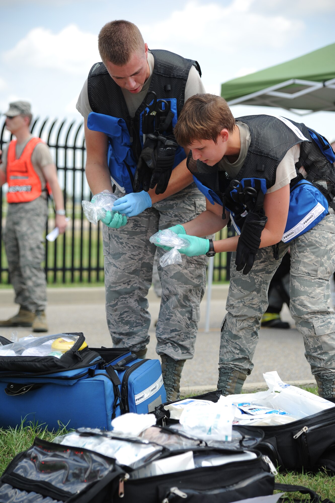 Airmen 1st Class Jason Parker and Demi Cook, 81st Aerospace Medicine Squadron, search their medical supplies for specific bandages and other medical tools to treat exercise “victims” July 18, 2012, at Keesler Air Force Base, Miss. Keesler held the three-day exercise to test the response of base personnel. In the exercise scenario, a disgruntled base employee sprayed harmful chemicals on Airmen in the Triangle training area injuring several people. Witnesses contacted 911 and within minutes, members of the 81st Security Forces Squadron apprehended the individual and first responders began decontamination and treatment of the victims. (U.S. Air Force photo by Kemberly Groue)
