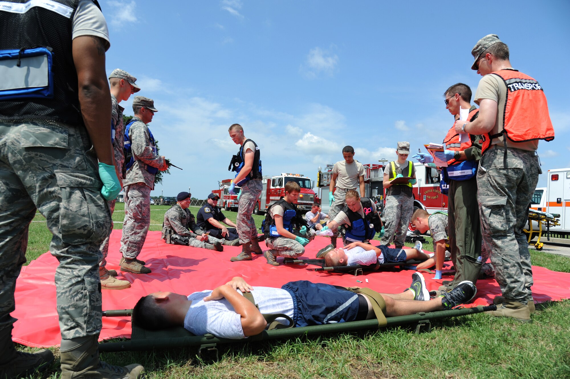 Members of the 81st Medical Group triage injured “victims” during an exercise July 18, 2012, at Keesler Air Force Base, Miss.  Keesler held the three-day exercise to test the response of base personnel. In the exercise scenario, a disgruntled base employee sprayed harmful chemicals on Airmen in the Triangle training area injuring several people. Witnesses contacted 911 and within minutes, members of the 81st Security Forces Squadron apprehended the individual and first responders began decontamination and treatment of the victims. (U.S. Air Force photo by Kemberly Groue)