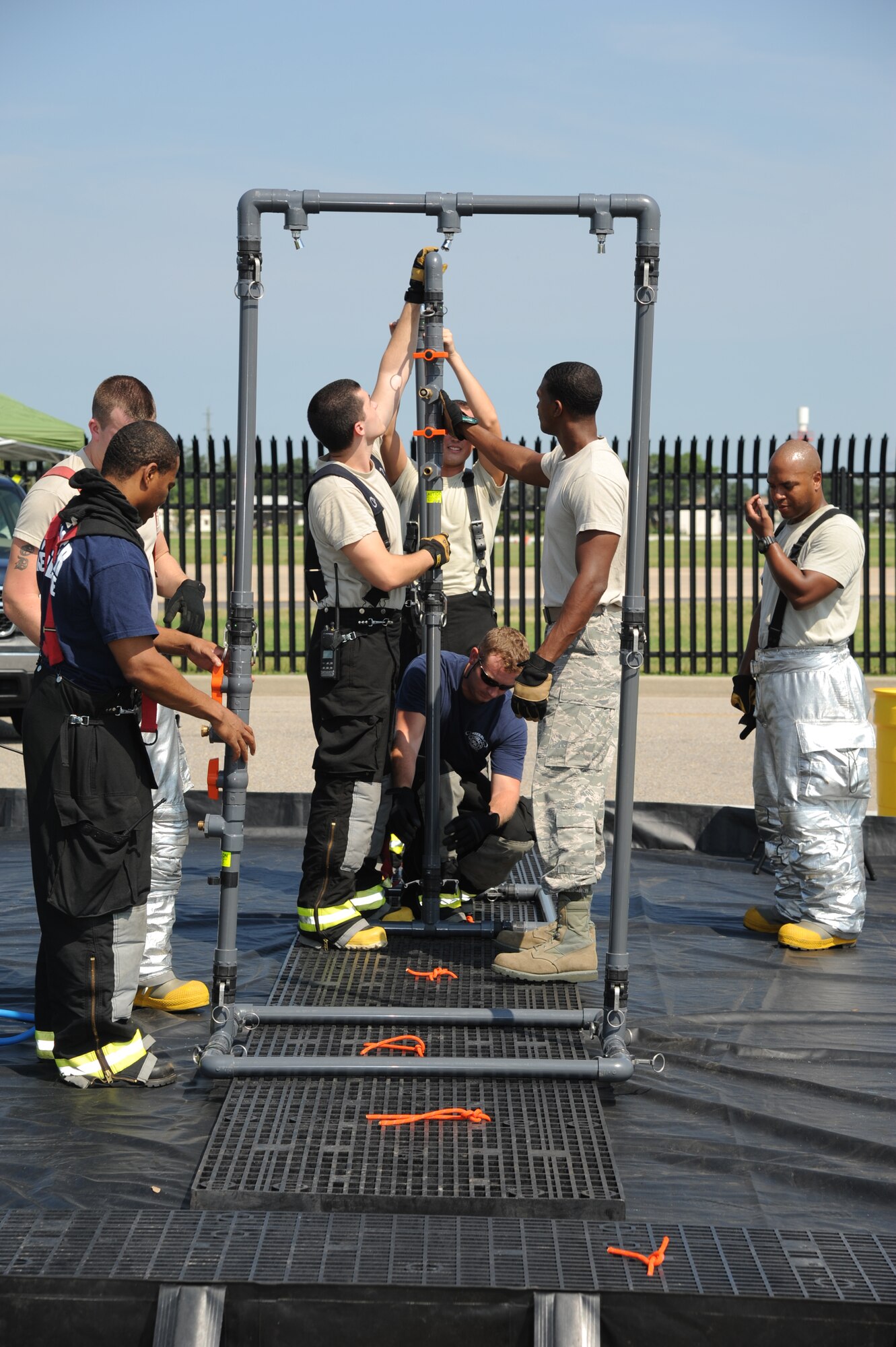 Keesler firefighters assemble equipment to decontaminate the “victims” during an exercise July 18, 2012, at Keesler Air Force Base, Miss.  Keesler held the three-day exercise to test the response of base personnel. In the exercise scenario, a disgruntled base employee sprayed harmful chemicals on Airmen in the Triangle training area injuring several people. Witnesses contacted 911 and within minutes, members of the 81st Security Forces Squadron apprehended the individual and first responders began decontamination and treatment of the victims. (U.S. Air Force photo by Kemberly Groue)