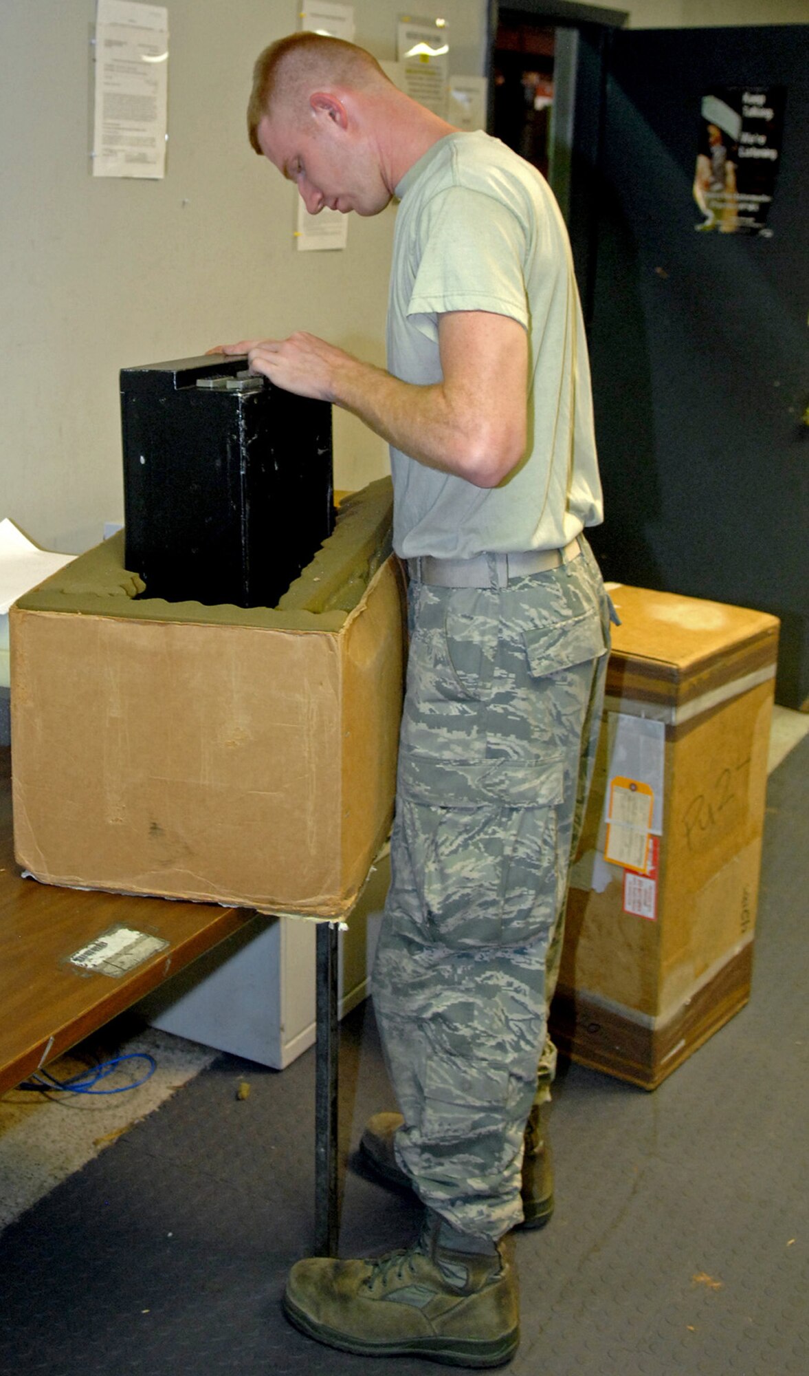 Senior Airman John Aubuchon, 20th Aircraft Maintenance Unit communication navigation journeyman, inspects a part needed for a red-ball maintenance action at Barksdale Air Force Base, La., July 18. Red-ball maintenance is when an aircraft has aircrew on-board and the plane is waiting for a problem to be fixed so it can take off on its mission. (U.S. Air Force photo/Staff Sgt. Jason McCasland)(RELEASED)