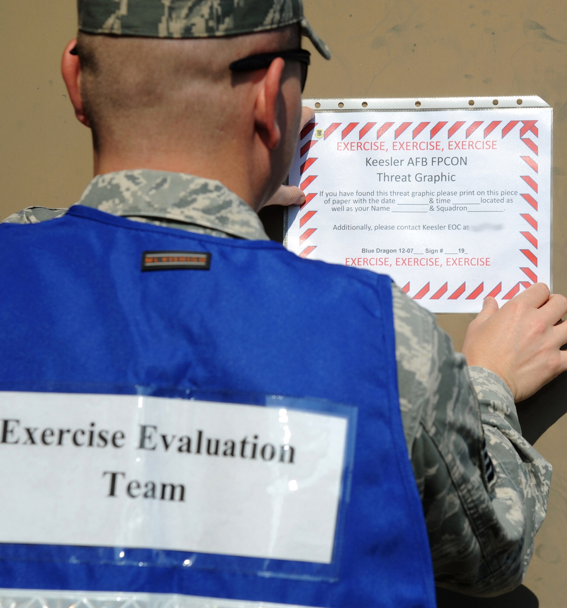 Master Sgt. Michael Funkhouser, 81st Training Wing exercise evaluation team member, posts a threat graphic during an exercise July 18, 2012, at Keesler Air Force Base, Miss.  Keesler held a three day exercise to test the response of base personnel.  Keesler held the three-day exercise to test the response of base personnel. In the exercise scenario, a disgruntled base employee sprayed harmful chemicals on Airmen in the Triangle training area injuring several people. Witnesses contacted 911 and within minutes, members of the 81st Security Forces Squadron apprehended the individual and first responders began decontamination and treatment of the victims. (U.S. Air Force photo by Kemberly Groue)