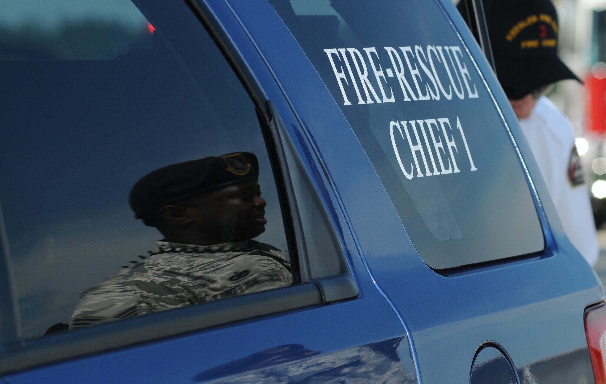 Tech. Sgt. Phillip Belle, 81st Security Forces Squadron, is reflected in the window of the fire-rescue chief’s vehicle during an exercise July 18, 2012, at Keesler Air Force Base, Miss.  Keesler held the three-day exercise to test the response of base personnel. In the exercise scenario, a disgruntled base employee sprayed harmful chemicals on Airmen in the Triangle training area injuring several people. Witnesses contacted 911 and within minutes, members of the 81st Security Forces Squadron apprehended the individual and first responders began decontamination and treatment of the victims. (U.S. Air Force photo by Kemberly Groue)