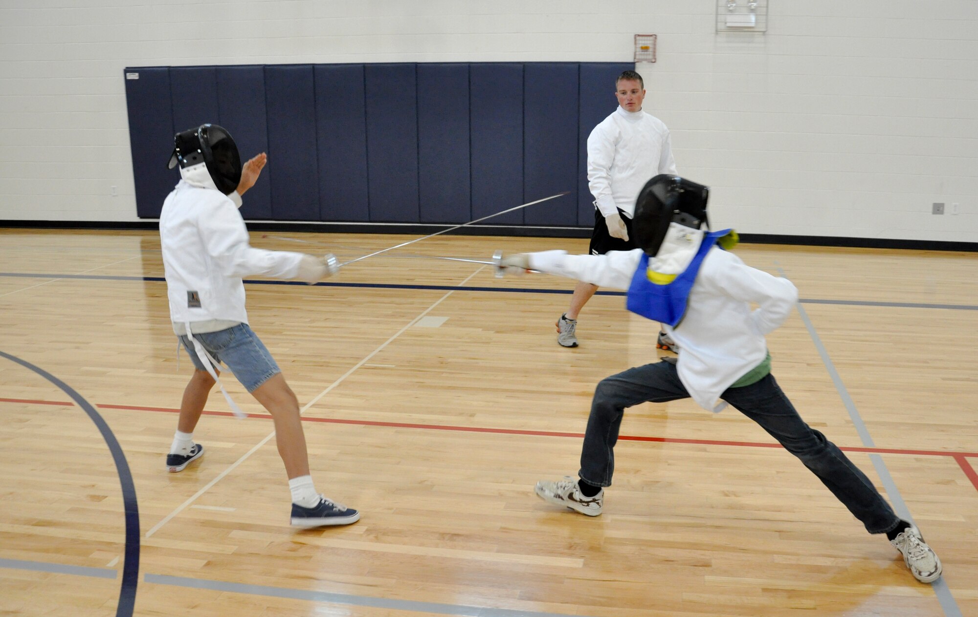 BUCKLEY AIR FORCE BASE, Colo. -- Daniel McMaster, left, and Shawn Crawford fence each other July 18, at the Buckley Youth Center. Children were able to participate in unique sports throughout the week, other sports including lacrosse, hand ball and badminton. (U.S. Air Force photo by Staff Sgt. Nicholas Rau)