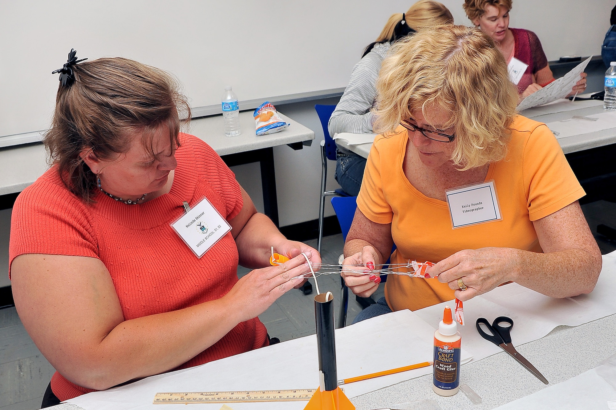 Melinda Skinner and Kelly Pounds put together a rocket that they will launch. The projects introduced in the STEM workshops show teachers how to integrate engineering into the classroom. (U.S. Air Force Photo/Elizabeth Andrews)