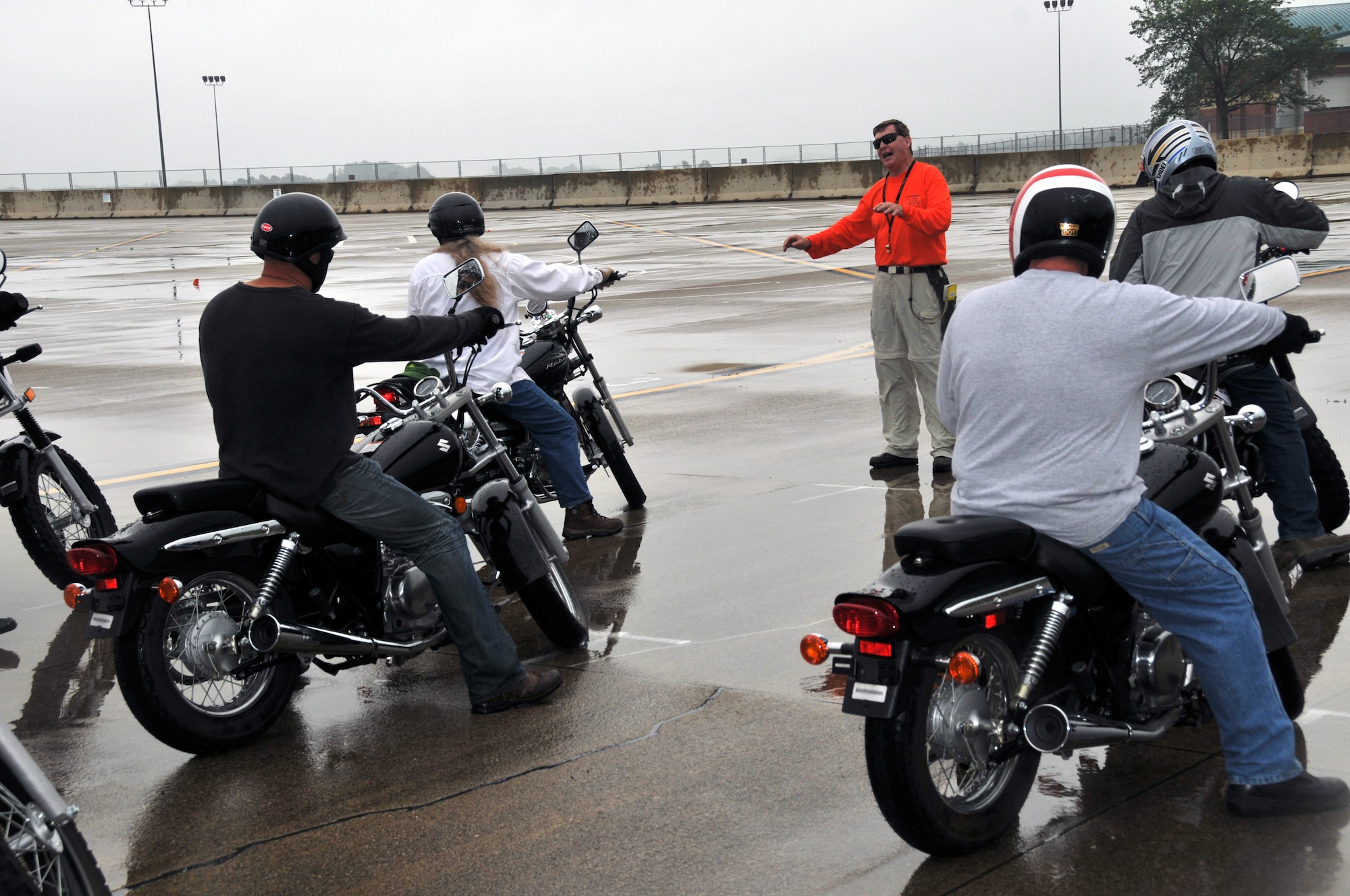 Greg Burton, motorcycle rider coach, gives instructions to motorcycle riders participating in a Motorcycle Ohio safety course at Springfield Air National Guard Base, Ohio for military members and retirees July 20 to enhance motorcycle skills, safety and awareness. The class titled Basic Rider Course is ran by the Ohio Department of Public Safety and teaches fundamental skills ranging from basic familiarization to hazard avoidance while riding a motorcycle. (U.S. Air Force photo by 2nd Lt. Michael Gibson)
