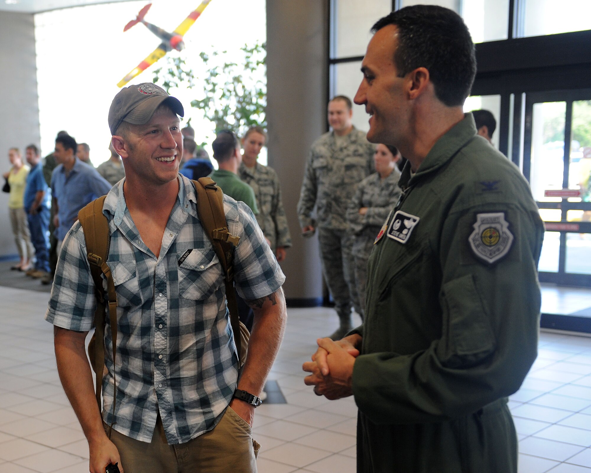 U.S. Air Force Col. Steven Gregg, 347th Rescue Group commander, speaks to Staff Sgt. Issaiah McPheron, 38th Rescue Squadron pararescueman, at the Valdosta Regional Airport, Valdosta, Ga., July 17, 2012. McPheron worked alongside other military branches in support of operations in Southwest Asia. (U.S. Air Force photo by Staff Sgt. Ciara Wymbs/Released)  