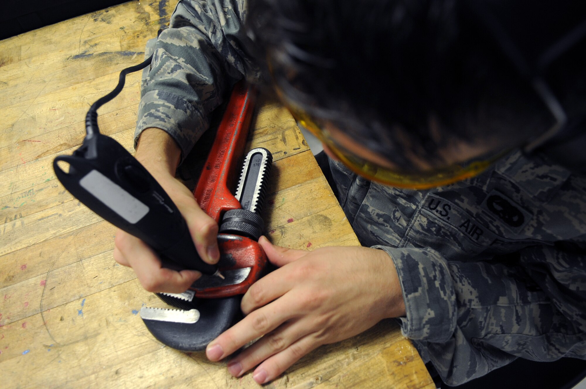 U.S. Air Force Senior Airman George Frondek, 354th Maintenance Squadron aerospace propulsion technician, engraves a wrench July 18, 2012, Eielson Air Force Base, Alaska. The serial number is engraved on every tool in case the tool is misplaced or found. (U.S. Air Force photo/Airman 1st Class Lauren-Taylor Garcia)