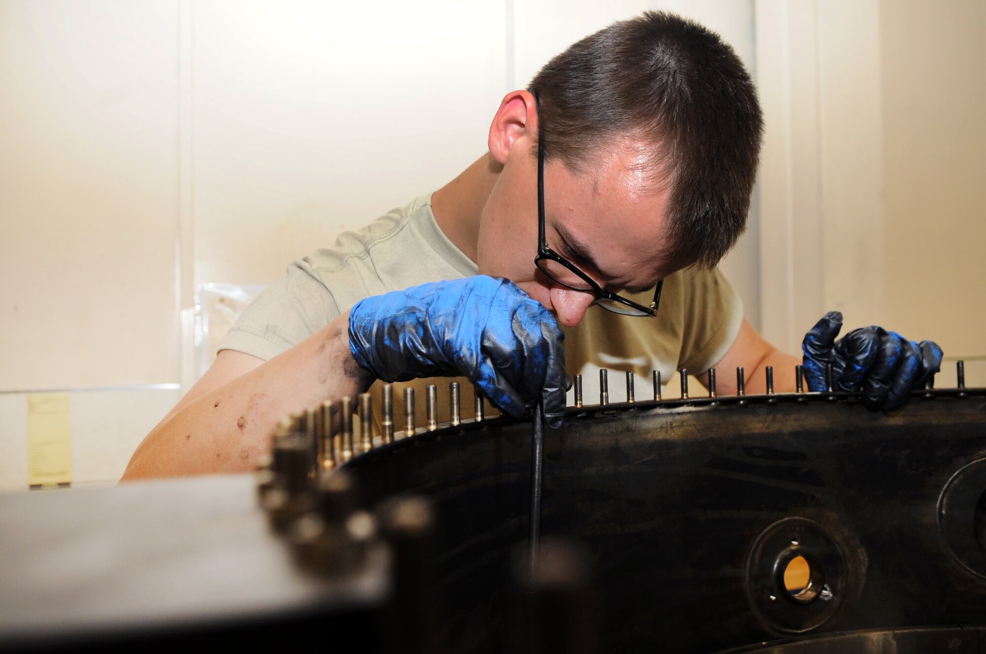 U.S. Air Force Airman 1st Class David Searer-Jones, 354th Maintenance Squadron aerospace propulsion technician, checks the bolts on an aircraft engine July 18, 2012, Eielson Air Force Base, Alaska. Searer-Jones checked the bolts to ensure they are properly tightened. (U.S. Air Force photo/Airman 1st Class Lauren-Taylor Garcia)