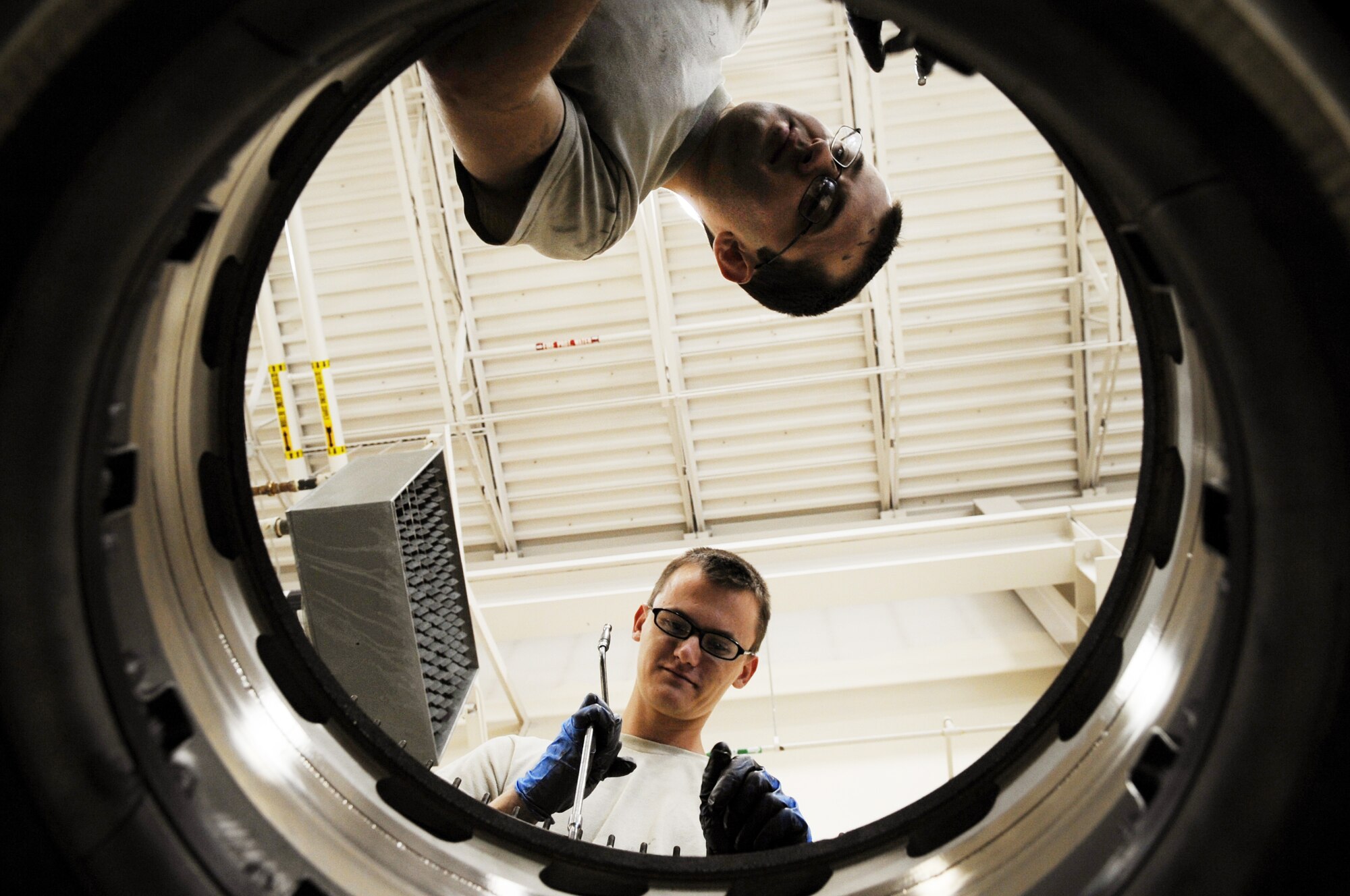 U.S. Air Force Airmen 1st Class David Searer-Jones and Charles Woods, 354th Maintenance Squadron aerospace propulsion technicians, tighten bolts on an aircraft engine July 18, 2012, Eielson Air Force Base, Alaska. The bolts are oiled prior to being tightened.  (U.S. Air Force photo/Airman 1st Class Lauren-Taylor Garcia)