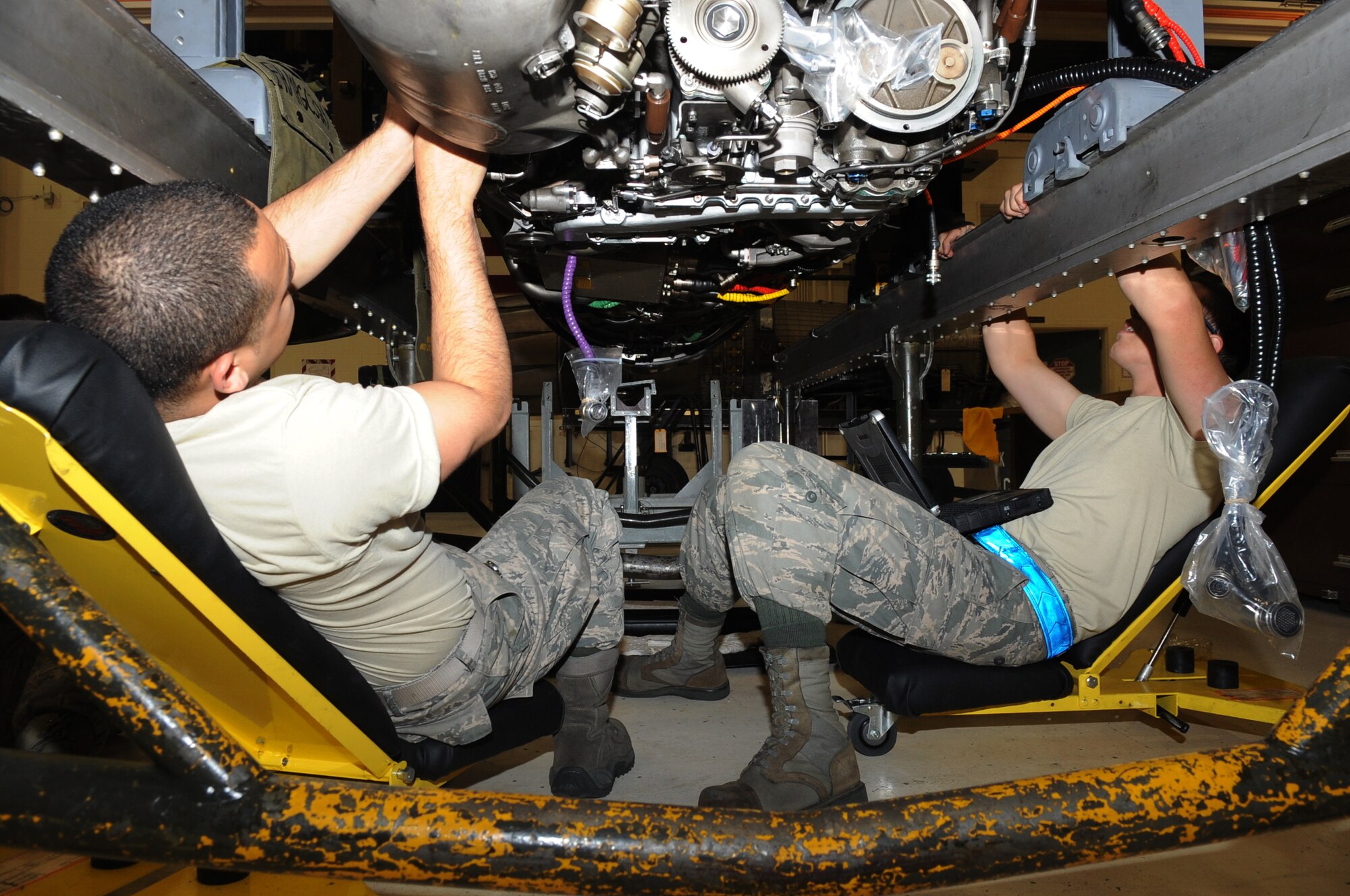 U.S. Air Force Airmen 1st Class Manuel Torres and Tyler Roseman, 354th Maintenance Squadron aerospace propulsion technicians, install a gear box on an aircraft engine July 18, 2012, Eielson Air Force Base, Alaska. The new gear box was installed to replace one covered in contaminated oil. (U.S. Air Force photo/Airman 1st Class Lauren-Taylor Garcia) 