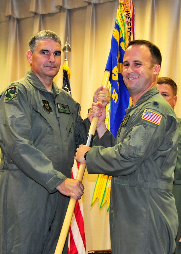 Colonel James Phillips, 919th Operations Group commander, left, passes the 5th Special Operations Squadron guidon to Lt. Col. Michael Lee during the squadron's change of command ceremony July 19, 2012, at Hurlburt Field, Fla.  The 5th SOS is a Total Force Enterprise unit whose members participate in the active-duty mission of the Air Force Special Operations Training Center at Hurlburt. While its Air Force Reserve members perform duty at Hurlburt as part of AFSOTC, the squadron administratively falls under the 919th Special Operations Wing at Duke Field, Fla. 