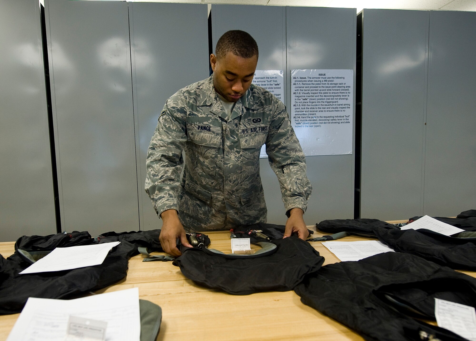 Airman Delonte Vance, 2nd Operations Support Squadron aircrew flight equipment journeyman, inspects a life preserver unit on Barksdale Air Force Base, La., July 19. The LPUs must be inspected yearly along with survival vests and other equipment. Other pieces, such as helmets and oxygen masks, are inspected every 30 days. LPUs inflate with air to help the wearer float if they are forced to eject over water. (U.S. Air Force photo/Staff Sgt. Chad Warren)(RELEASED)