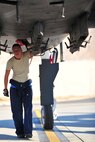 U.S. Air Force Airman 1st Class Grace Wheeler, a crew chief with the 23d Aircraft Maintenance Squadron, 74th Aircraft Maintenance Unit, checks the bottom of an A-10C Thunderbolt II for leaks and cracks during a post-flight inspection at Nellis Air Force Base, Nev., July 16,2012. The 23d AMXS/74th AMU is deployed to Nellis in support of the Red Flag 12-4 exercise, which runs July 16-27, 2012. Wheeler is one of two female crew chiefs in her unit participating in Red Flag and hopes to gain some more experience and training that will help her prepare for future deployments. (U.S. Air Force photo by Staff Sgt. Stephanie Mancha/Released) 