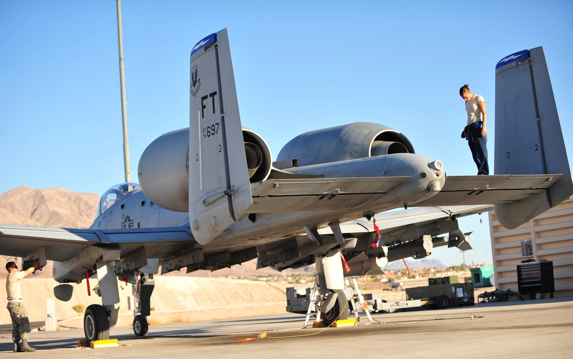 U.S. Air Force Airman 1st Class Grace Wheeler, a crew chief with the 23d Aircraft Maintenance Squadron, 74th Aircraft Maintenance Unit, checks the tail of an  A-10C Thunderbolt II during a post-flight inspection at Nellis Air Force Base, Nev., July 16,2012. The 23d AMXS/74th AMU is deployed to Nellis in support of the Red Flag 12-4 exercise, which runs July 16-27, 2012. Fourteen A-10s are deployed to Nellis from Moody Air Force Base, Ga., along with more than 200 aircrew, maintainers and support personnel.  (U.S. Air Force photo by Staff Sgt. Stephanie Mancha/Released) 