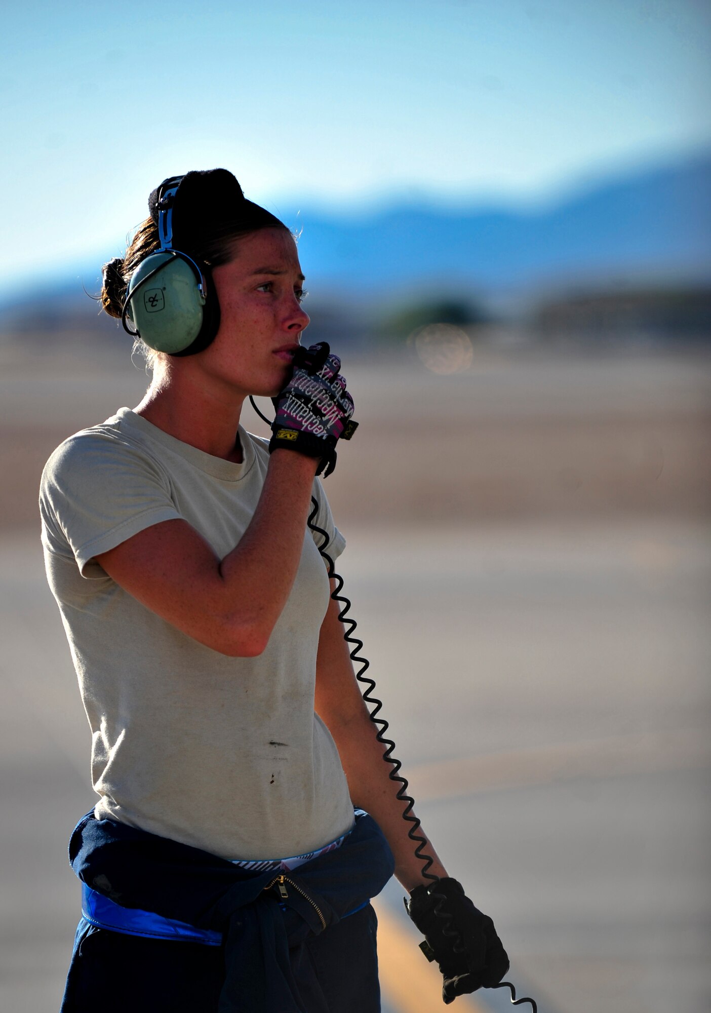 U.S. Air Force Airman 1st Class Grace Wheeler, a crew chief with the 23d Aircraft Maintenance Squadron, 74th Aircraft Maintenance Unit, communicates with an A-10C Thunderbolt II  pilot during a post-flight inspection at Nellis Air Force Base, Nev., following a training mission at the Nevada Training and Test Range July 16, 2012.  Wheeler is stationed at Moody AFB, Ga., and is participating in the Red Flag 12-4 exercise. (U.S. Air Force photo by Staff Sgt. Stephanie Mancha/Released)