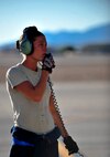 U.S. Air Force Airman 1st Class Grace Wheeler, a crew chief with the 23d Aircraft Maintenance Squadron, 74th Aircraft Maintenance Unit, communicates with an A-10C Thunderbolt II  pilot during a post-flight inspection at Nellis Air Force Base, Nev., following a training mission at the Nevada Training and Test Range July 16, 2012.  Wheeler is stationed at Moody AFB, Ga., and is participating in the Red Flag 12-4 exercise. (U.S. Air Force photo by Staff Sgt. Stephanie Mancha/Released)