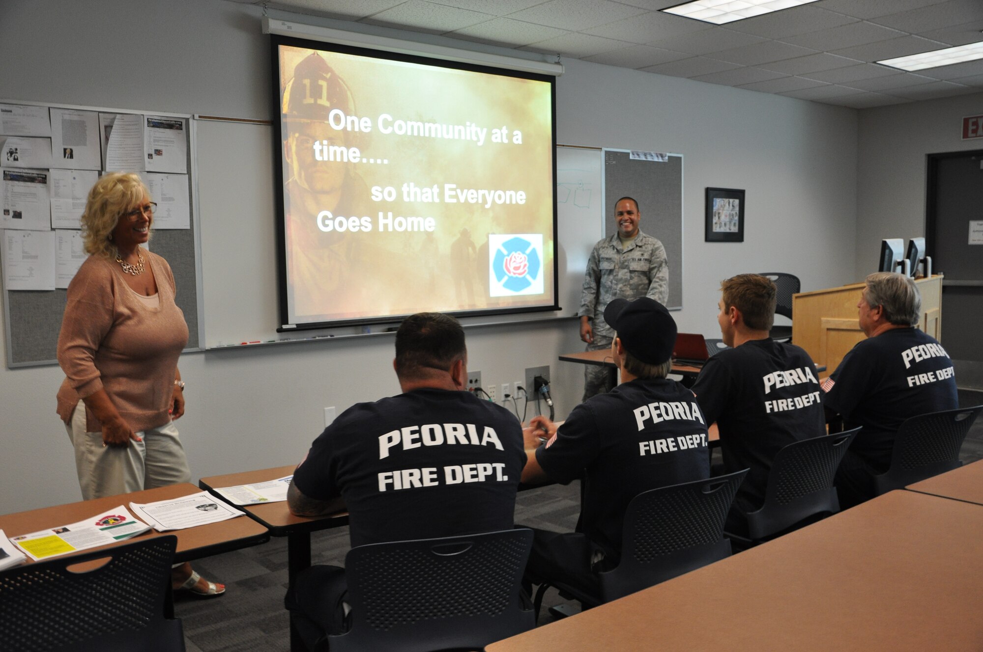 Sharon Kozak, 56th Medical Operations Squadron family advocacy outreach manager, and Senior Airman Brett Chapman, 56th MDOS mental health technician, brief firefighters on suicide prevention July 16 at the Glendale Training Center. (U.S. Air Force photo by Senior Airman Melanie Holochwost)