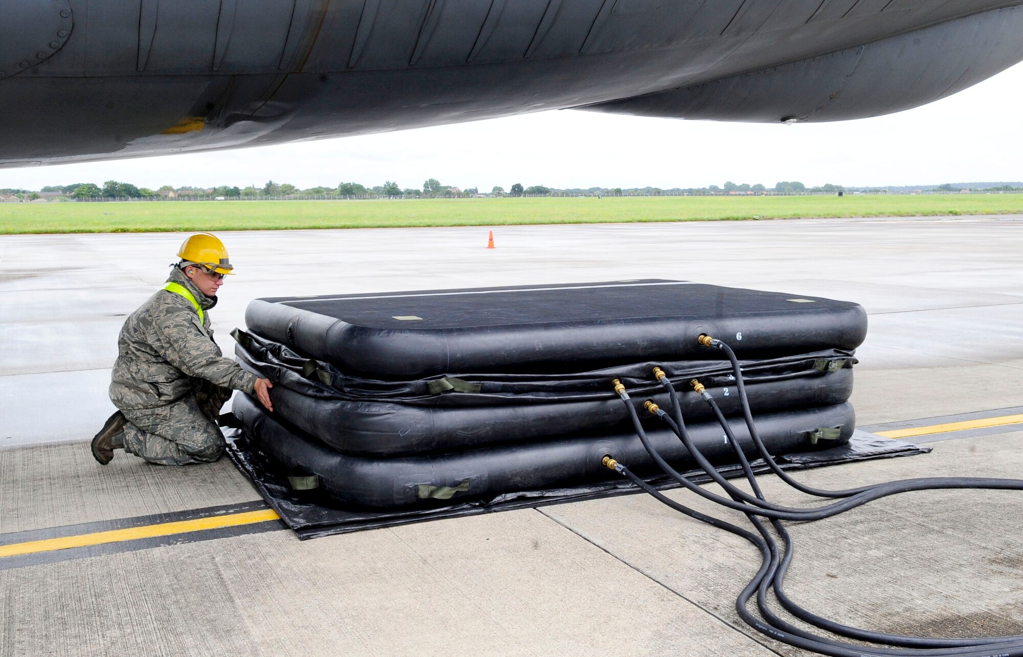 RAF MILDENHALL, England – Staff. Sgt. Joseph Cid, 100th Maintenance Squadron repair and reclamation craftsman, checks lifting bags to ensure they are not leaking during a crash recovery exercise on the flightline at RAF Mildenhall July 20, 2012. Lifting bags are placed in key points around an aircraft and are used to lift and stabilize it. (U.S. Air Force photo/Senior Airman Ethan Morgan)