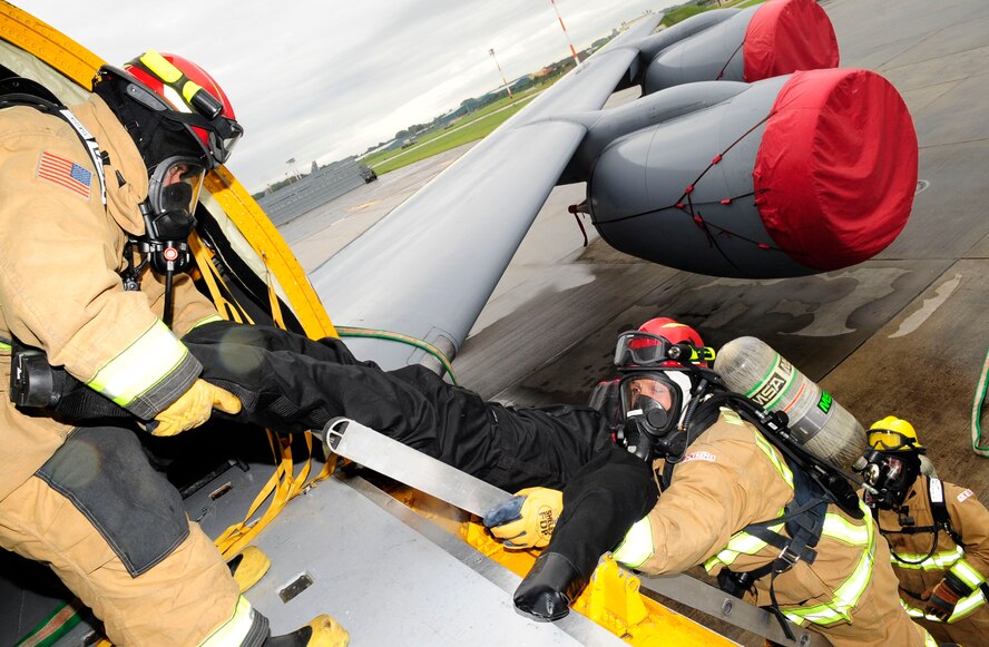 RAF MILDENHALL, England-- Firefighters from the 100th Civil Engineer Squadron evacuate a simulated casualty during a crash recovery exercise on the flightline at RAF Mildenhall July 20, 2012. Firefighters removed three mock casualties from the simulated wreckage. (U.S. Air Force photo/Senior Airman Ethan Morgan)