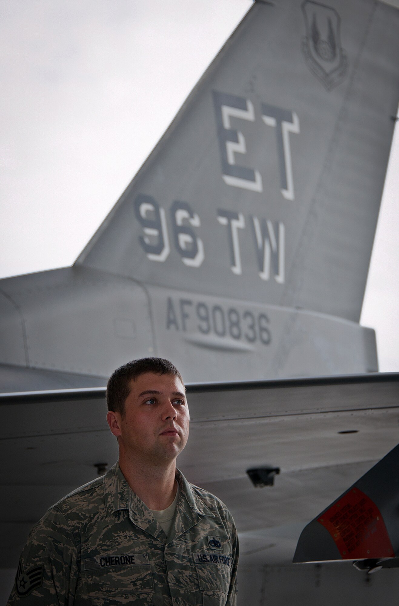 Staff Sgt. Brad Cherone, of the 96th Aircraft Maintenance Squadron, stands by the new wing flagship at the base’s transition ceremony July 18 at Eglin Air Force Base, Fla. The official activation of the 96th Test Wing combined the 96th Air Base Wing and 46th Test Wing. (U.S. Air Force photo/Samuel King Jr.)