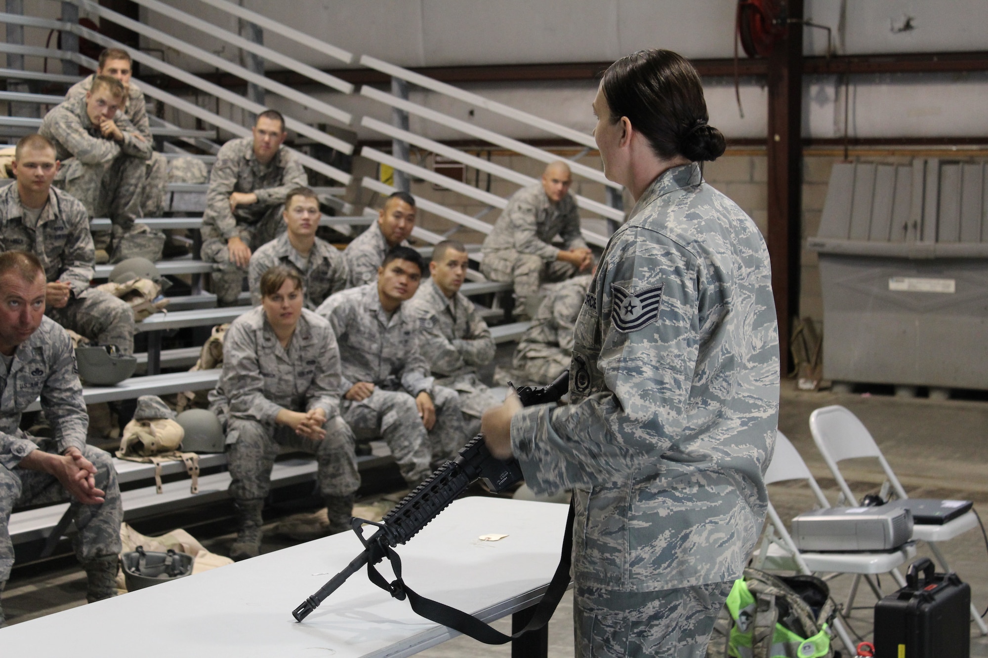 PETERSON AIR FORCE BASE, Colo. -- Tech. Sgt. Vanassa Martinez, 21st Security Forces Squadron, instructs members of the 21st Civil Engineer Squadron on proper weapons handling procedures June 21, 2012. During the training, Martinez discussed proper weapons safety, a paramount skill for Airmen. (U.S. Air Force photo/Staff Sgt. Shakib Rahman)