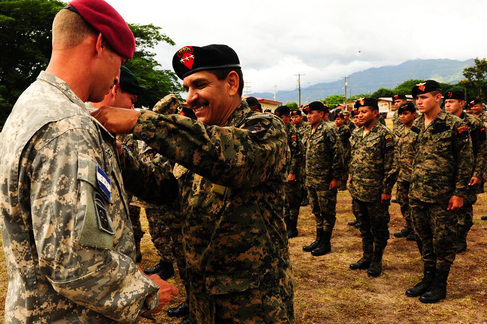 SOTO CANO AB, Honduras – A Honduran jumpmaster presents a U.S. Army jumpmaster Honduran jump wings during a wing exchange ceremony following a combined airborne exercise at Joint Task Force-Bravo.  (U.S. Air Force photo by 1st Lt. Christopher Diaz)