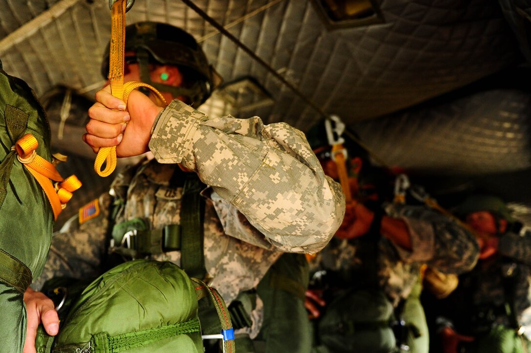 SOTO CANO AB, Honduras – U.S. Army paratroopers hold the static line in a CH-47 Chinook helicopter during a combined airborne exercise at Joint Task Force-Bravo. (U.S. Air Force photo by 1st Lt. Christopher Diaz)