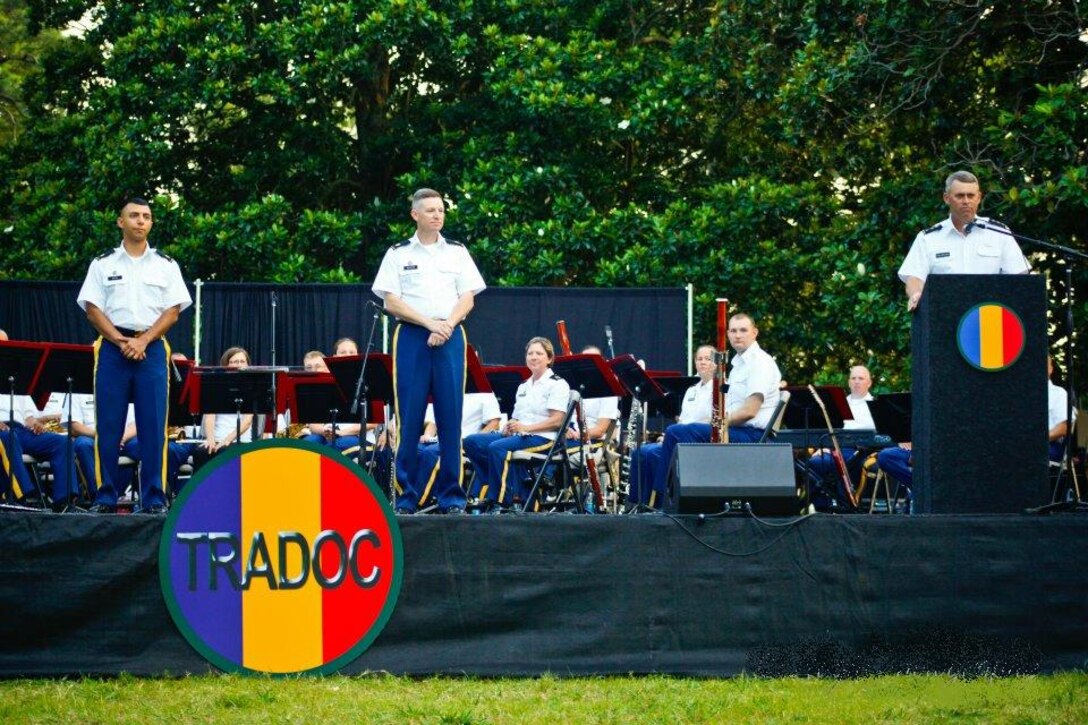 U.S. Army Lt. Gen. David Halverson, right, hosted the U.S. Army’s Training and Doctrine Command Band Change of Command ceremony in Magnolia Park at Fort Eustis, Va.,  July 5.  Maj. Leonel Pena, left, assumed command from Maj. Scott McKenzie as part of the Music Under the Stars Concert. (Courtesy photo by Ginny Hagin)